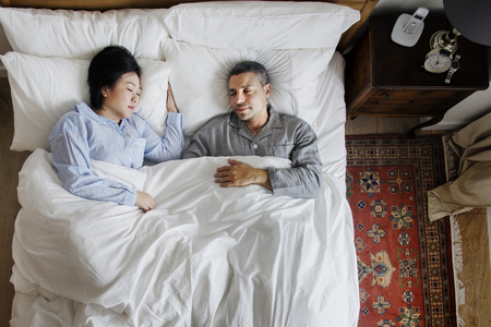 Interracial couple sleeping together on the bed