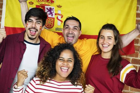 Friends cheering with painted flag