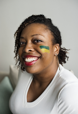 Friends cheering her team with painted flag