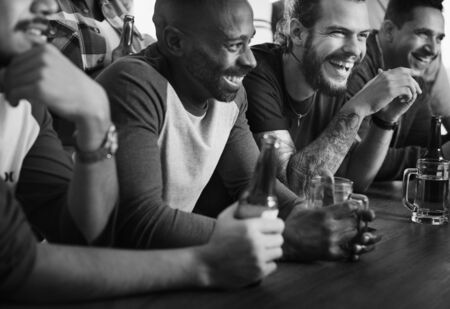 Frieds cheering sport at bar together