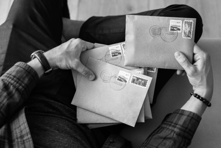 Aerial view of man selecting envelopes