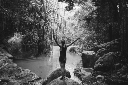 White woman enjoying the waterfall