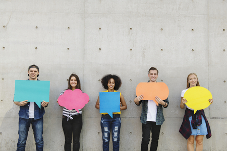 Group of young adults outdoors holding empty placard copyspace thought bubbles