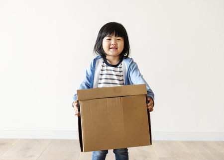 Asian kid helping move now house