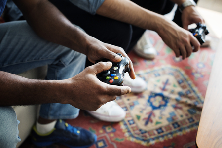 People playing video game while holding controller