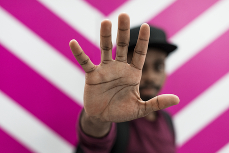African man doing a "Talk to the hand!" pose