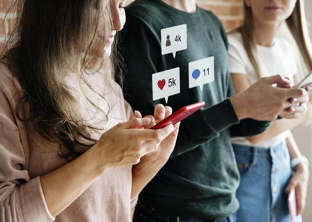 Happy friends using smartphones social media concept