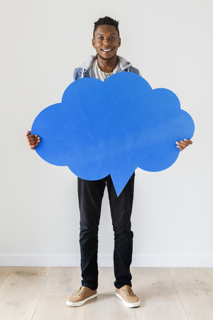Happy African American man holding copyspace speech bubble