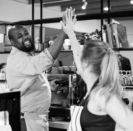 Colleagues give a high five to each other