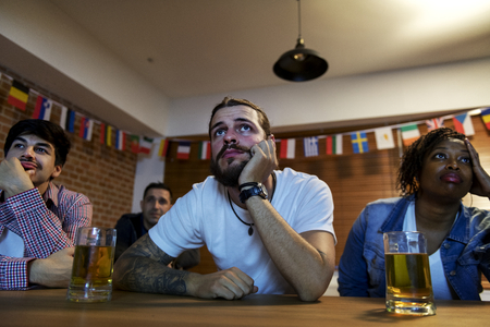 Frieds cheering sport at bar together
