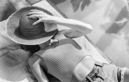 Young woman relaxing beside a swimming pool