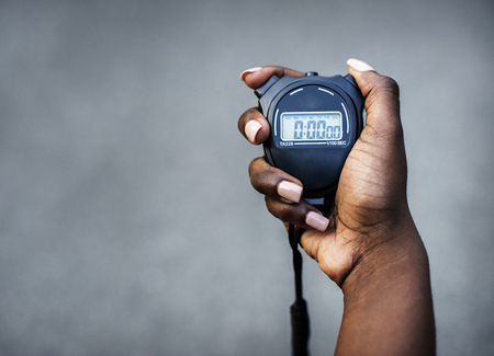 Hand holding a stopwatch