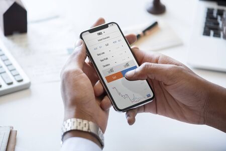 Businessman checking stock market online
