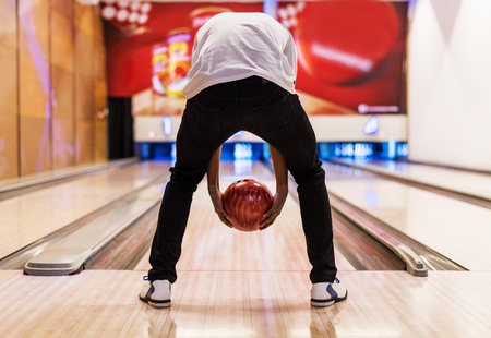 Boy bowling with two hands