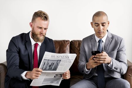 Two businessman sitting on a couch