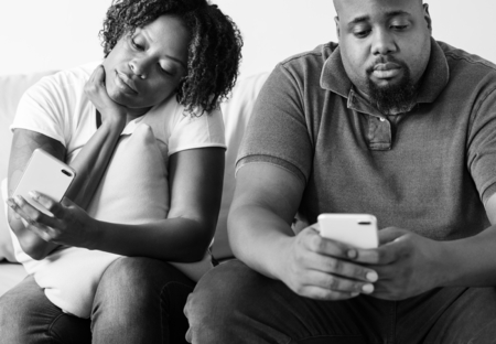Black couple using digital device