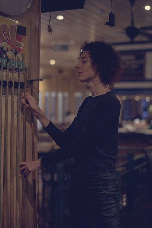 Woman picking up a cue stick