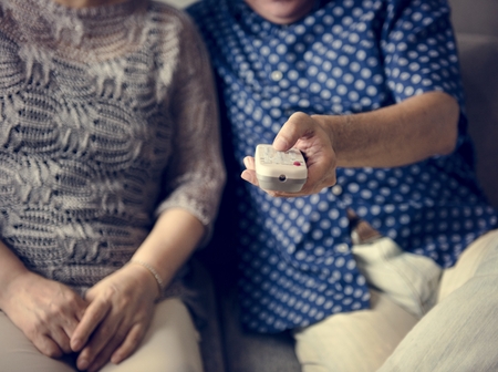 Asian senior couple sitting together at sofa