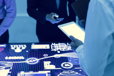 Hands holding using digital tablet in a technology meeting