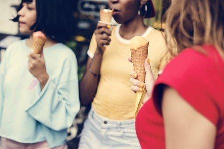 Group of diverse women eating ice cream together