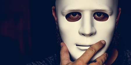 Anonymous with the mask looking at camera