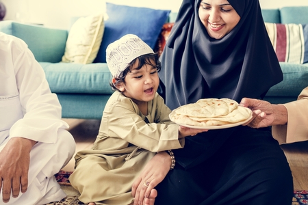 Muslim family having dinner on the floor