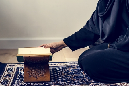 Muslim woman reading from the quran