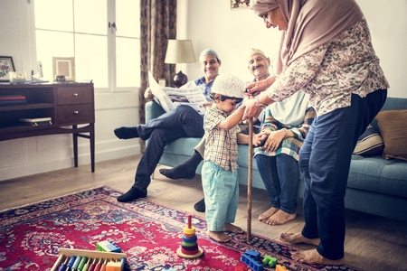 Muslim family relaxing in the home