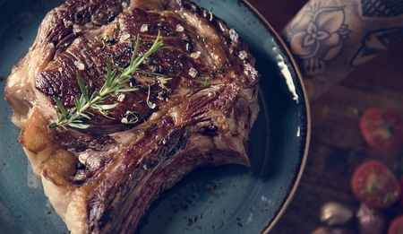Tomahawk on a plate with garnish food photography recipe idea