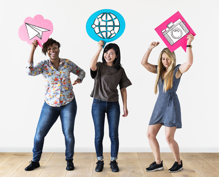 Cheerful women holding speech bubbles