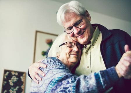Senior couple dancing in the livingroom
