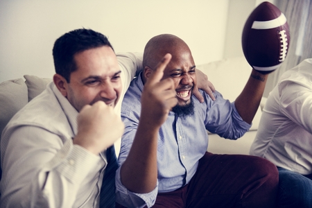 Friends cheering sport league together