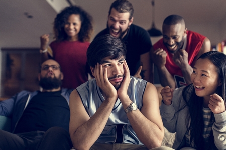 Friends cheering sport league together