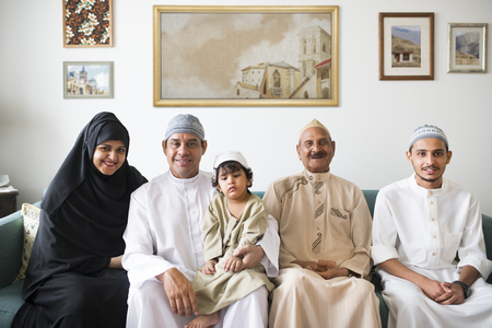 Muslim family relaxing in the home