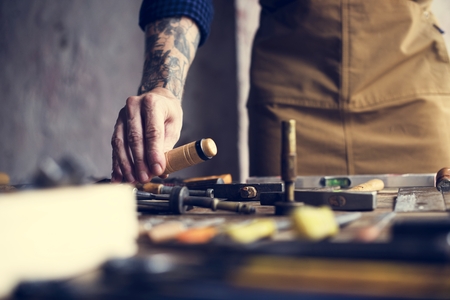 Foto de Closeup of carpenter man working with tools equipment set - Imagen libre de derechos