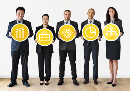 Business people holding financial icons