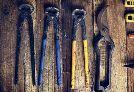 Aerial view of pliers set on wooden table