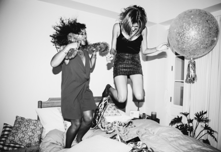 Girls jumping on the bed together