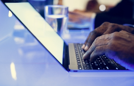 Hand on a laptop working at cyber space table