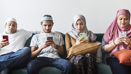 Muslim friends using social media on phones
