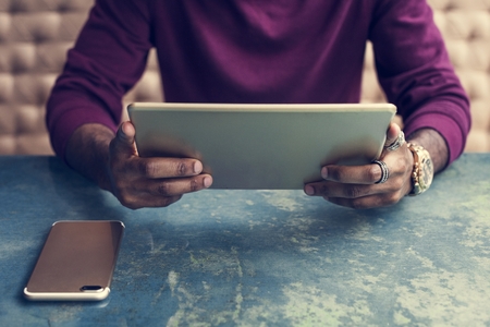 African man using digital tablet