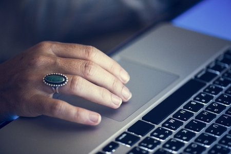 Hand working typing on laptop