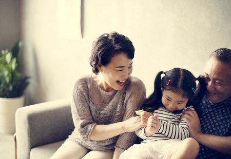 Asian family grandparent and niece playing togetehr