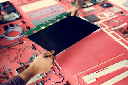 Hands holding a computer component part