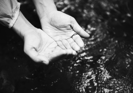 Woman getting some clear water from the river