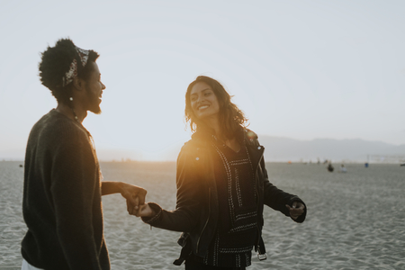 Happy couple dancing at the beach