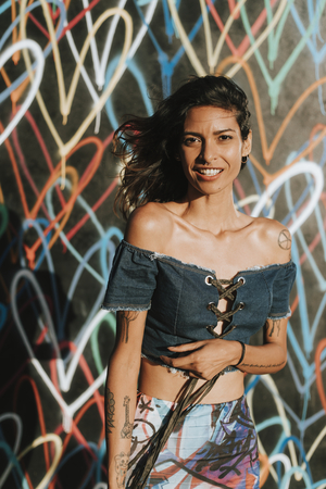 Beautiful model posing by a wall