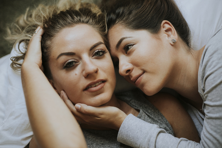 Lesbian couple together in bed