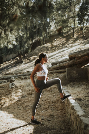 Woman stretching while on a hike