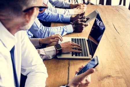 Business people in a meeting using devices